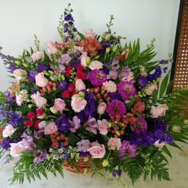 Large mixed flower basket with pink, purple, and red blooms