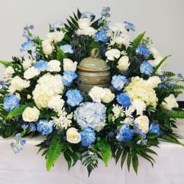 Blue and white floral arrangement with a decorative urn centerpiece