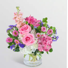 Pink and purple mixed bouquet in a clear glass vase