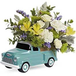 Floral arrangement in a turquoise vintage truck container