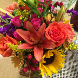 Colorful bouquet with roses, lilies, and a sunflower