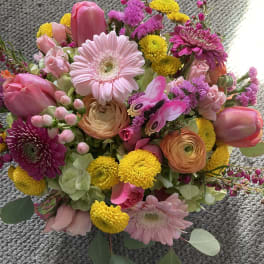 Mixed bouquet with pink gerberas, tulips, and yellow pompon flowers