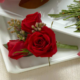 Red rose boutonniere on a white tray