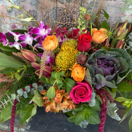 Colorful mixed bouquet with orchids, roses, and chrysanthemums