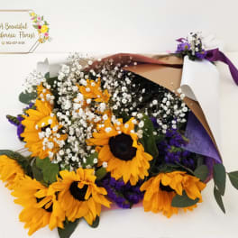 Bouquet of yellow sunflowers with white baby's breath and purple filler flowers