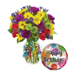 Colorful mixed bouquet in a glass vase with a Happy Birthday balloon