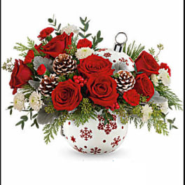 Red roses and white flowers in a snowflake-decorated vase