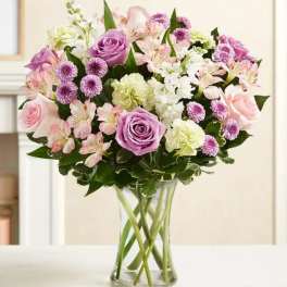 Bouquet of pink and lavender flowers in a clear glass vase