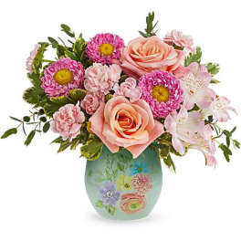 Pink roses and daisies in a painted ceramic vase