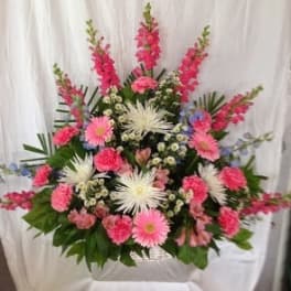 Large pink and white floral arrangement with gerbera daisies and carnations