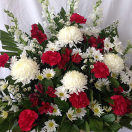 Basket arrangement of red and white flowers with daisies and chrysanthemums