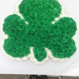 Green and white chrysanthemum arrangement shaped like a clover