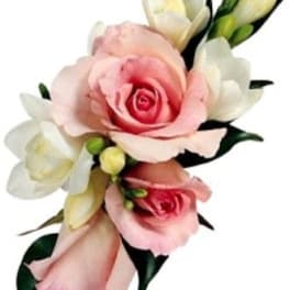 Small corsage-style cluster of pink roses and white freesia buds