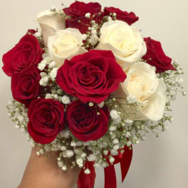 Bouquet of red and white roses with baby's breath and a red ribbon