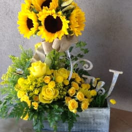 Yellow sunflower and rose arrangement in a wooden box