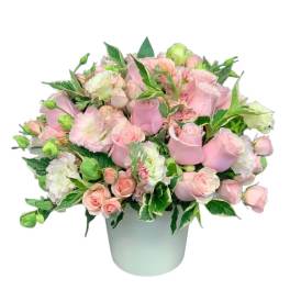 Pink roses and carnations arranged in a white vase