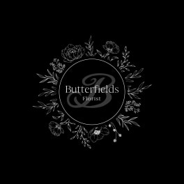 Black florist logo with white floral wreath and Butterfields Florist text