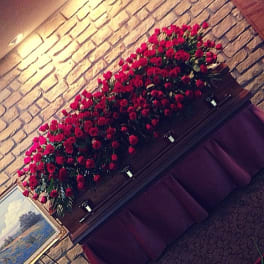 Large arrangement of red roses displayed on a mantel