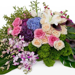 Mixed bouquet with pink roses, white lilies, and purple blooms