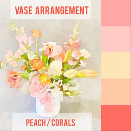 Peach and pink flowers arranged in a white vase