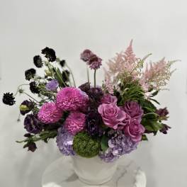 Pink and purple mixed bouquet in a white vase