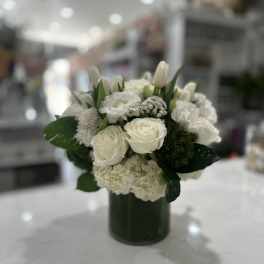White floral arrangement in a dark green vase
