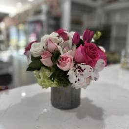 Pink and white rose bouquet in a gray vase