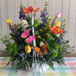 Colorful flower basket with tulips, daisies, and butterflies