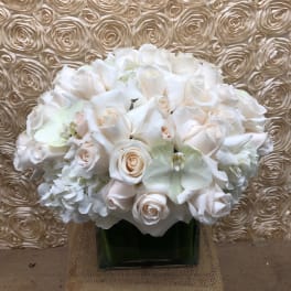White rose bouquet in a square glass vase