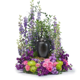 Purple and pink floral urn arrangement with a black urn centerpiece