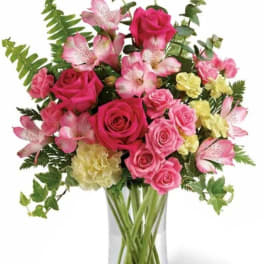Pink roses and alstroemeria in a clear glass vase