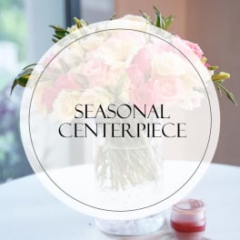 Pink and white flower centerpiece in a clear glass vase