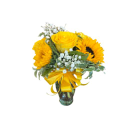 Yellow roses and sunflowers in a glass vase with a yellow ribbon