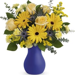 Yellow roses and daisies in a blue vase