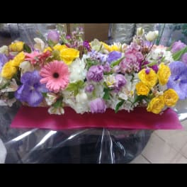 Mixed bouquet with yellow roses, pink gerbera daisies, and purple blooms