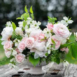 Pink and white floral arrangement in a white vase