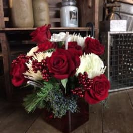 Red roses and white chrysanthemums in a dark vase