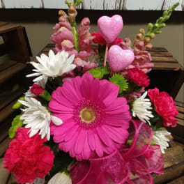 Pink gerbera bouquet with white daisies, carnations, and glitter heart picks