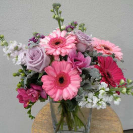 Pink and lavender mixed bouquet in a clear glass vase