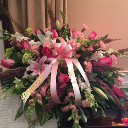 Large pink and white floral spray with a ribbon bow