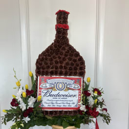 Budweiser bottle-shaped floral arrangement with red, white, and yellow flowers