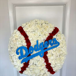Round white floral wreath with red stripes and a blue Dodgers sign