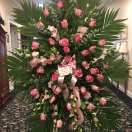 Large standing floral spray with pink roses and orchids
