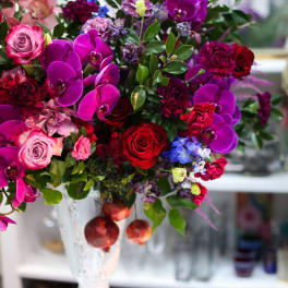 Bouquet of pink and purple flowers in a white vase