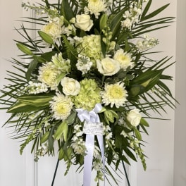 Standing floral spray with white roses and pale green blooms