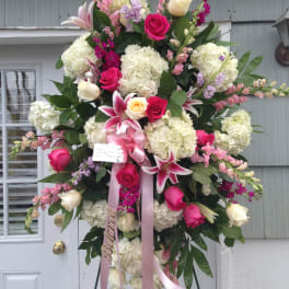 Large standing floral spray with pink and white flowers on an easel