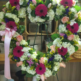 Heart-shaped floral wreath with pink gerberas and roses