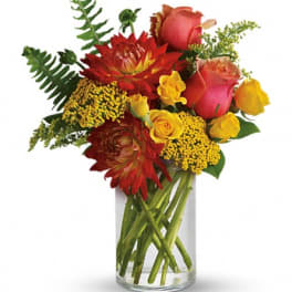 Bouquet of red and yellow flowers in a clear glass vase