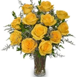 Yellow roses arranged in a clear glass vase
