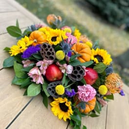 Autumn bouquet with sunflowers, pumpkins, and apples
